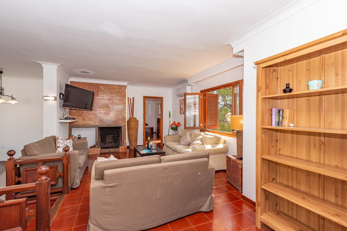 A living room with a fireplace and a flat screen tv