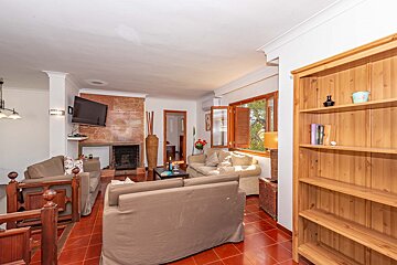 A living room with a fireplace and a flat screen tv