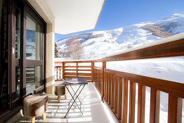 A balcony with a view of snowy mountains