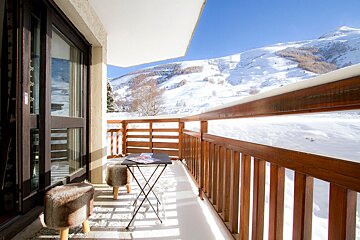 A balcony with a view of snowy mountains