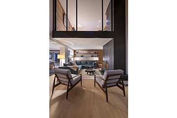 A living room with two chairs and a couch