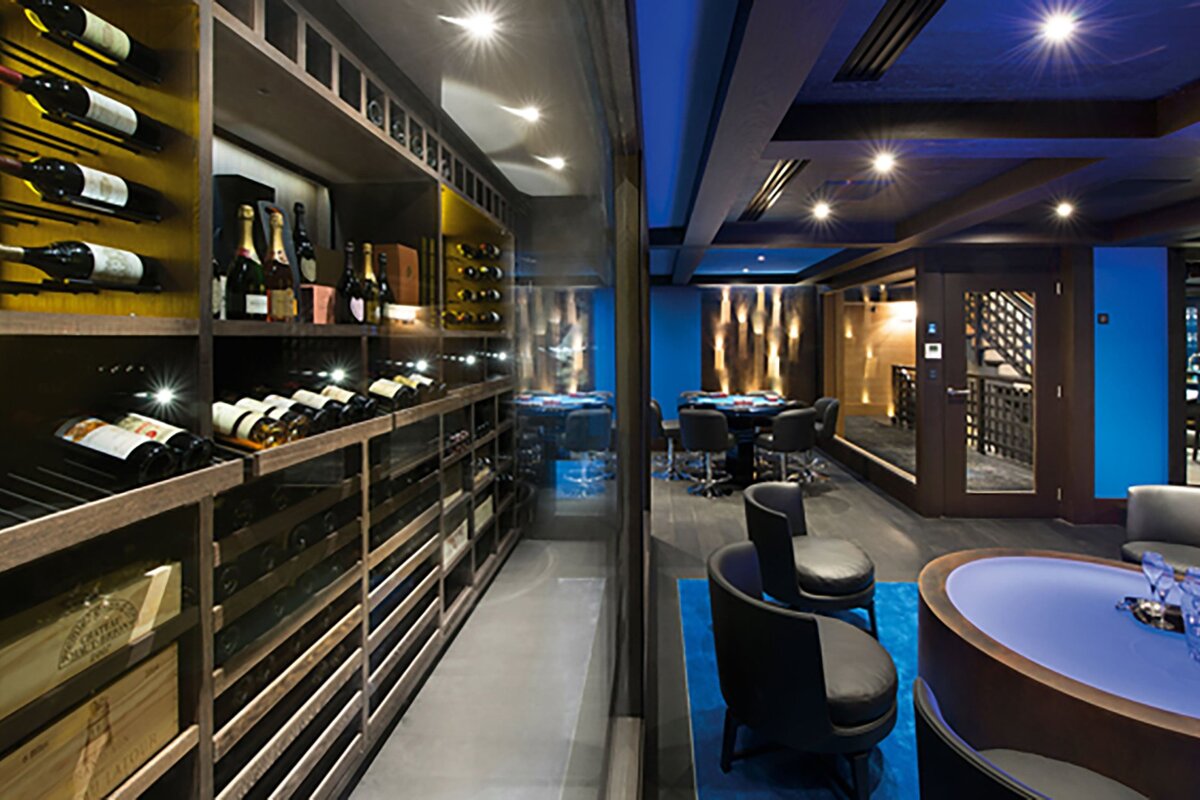 A bottle of champagne sits on a shelf in a wine cellar
