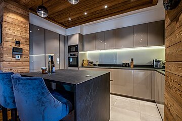 A kitchen with a bottle of wine on the counter
