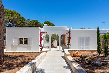 A white house with a walkway leading to it