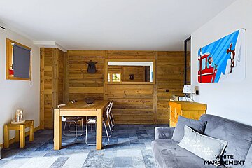 A living room with a couch and a table with the word rental on it