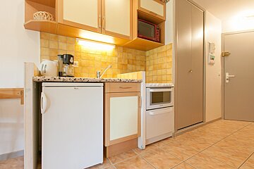 A small kitchen with a whirlpool refrigerator