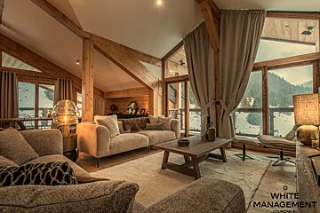 A bedroom with a picture on the wall above the bed