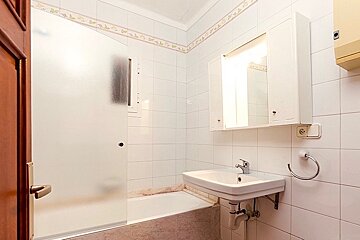 A bathroom with a sink a mirror and a bathtub