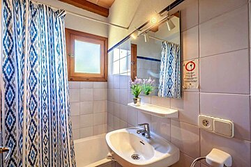 A bathroom with a sign on the wall that says