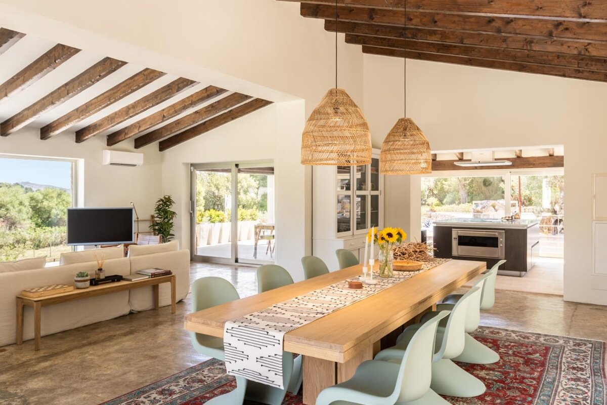 A dining room with a long table and chairs