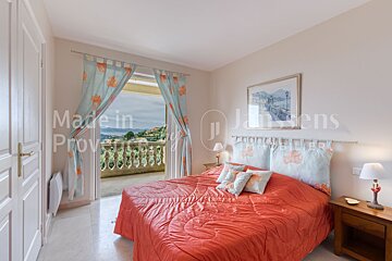 A bedroom with a bed and a balcony made in provence