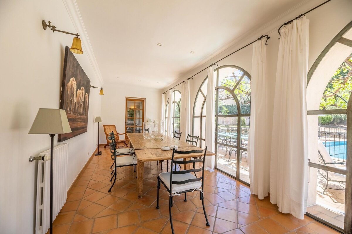 A dining room with a large table and chairs