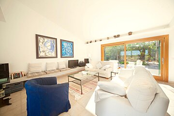 A living room with a couch and two chairs