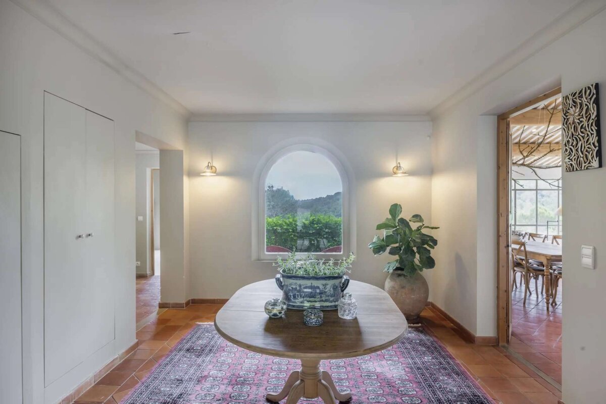 A round table in a hallway with a plant on it