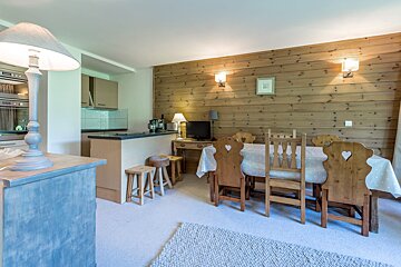 A living room with a table and chairs with hearts on them