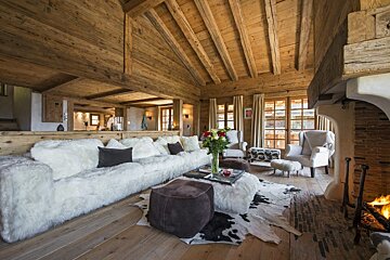 A living room with a couch and chairs and a fireplace