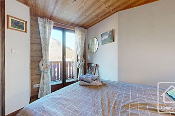 A bedroom with a bed and a picture on the wall that says alpine property