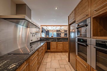 A kitchen with wooden cabinets and stainless steel appliances