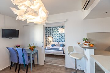 A room with a sliding door that leads to a bedroom