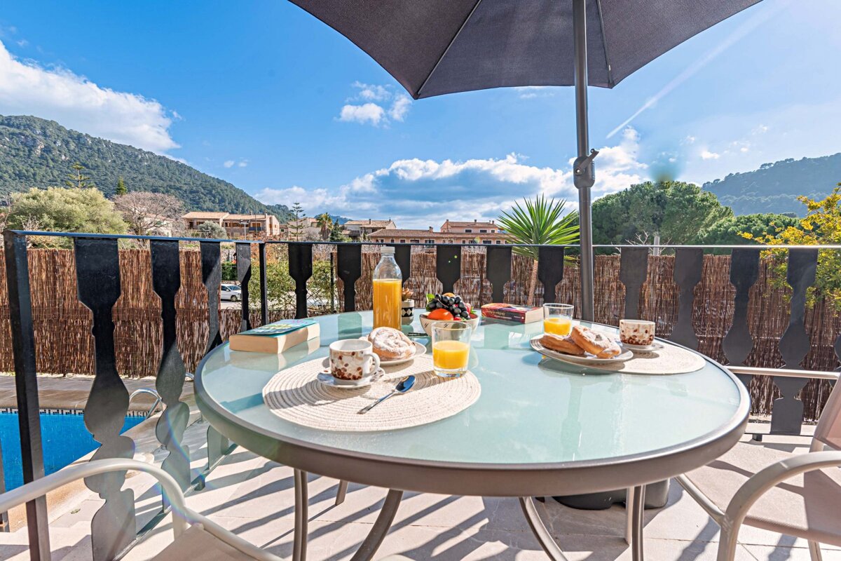 A table with a plate of food and a bottle of orange juice on it