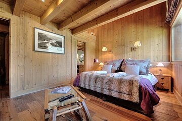 A bedroom with a bed and a picture on the wall