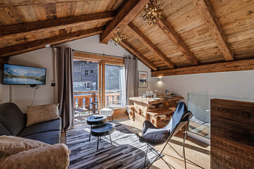 A living room with a picture of morzine on the wall