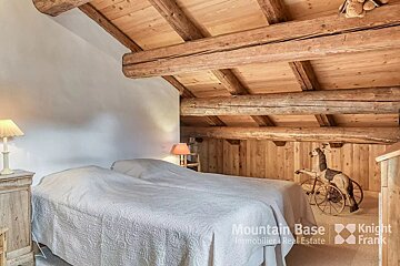 A bedroom with a bed and a knight frank logo