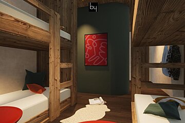 A room with bunk beds and a picture on the wall that says by