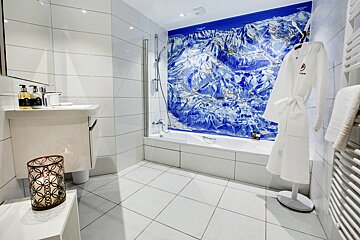 A bathroom with a bathtub and a map on the wall