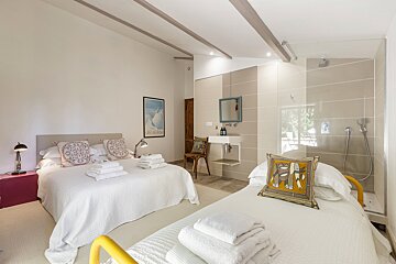 A bedroom with two beds and a picture on the wall that says