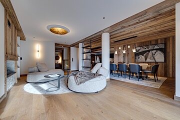 A living room with a couch a chair and a table