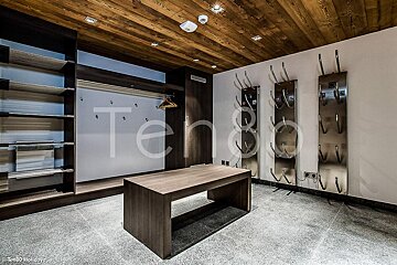 A room with a wooden ceiling and the word tend on the wall