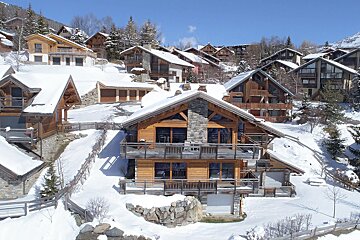 A row of snow covered houses on a hillside