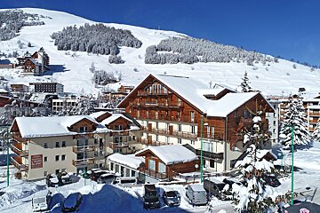 A large snow covered building with a sign that says