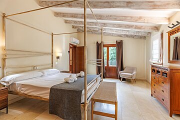 A bedroom with a canopy bed and a dresser