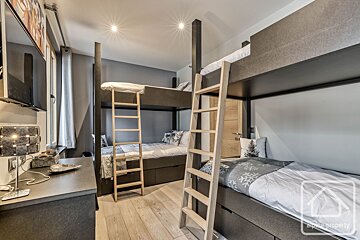 A bedroom with bunk beds and a sign that says alpha property
