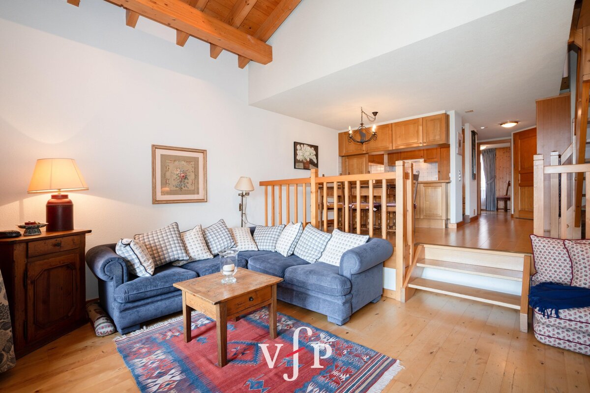 A living room with a blue couch and a wooden table with vip written on it