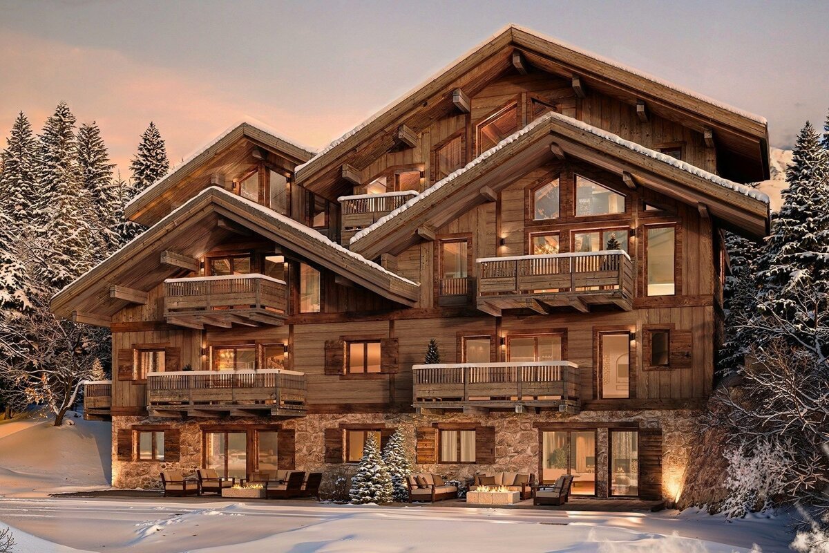 A stunning wooden mountain chalet with multiple balconies and glowing windows, set in a snowy forest at dusk.