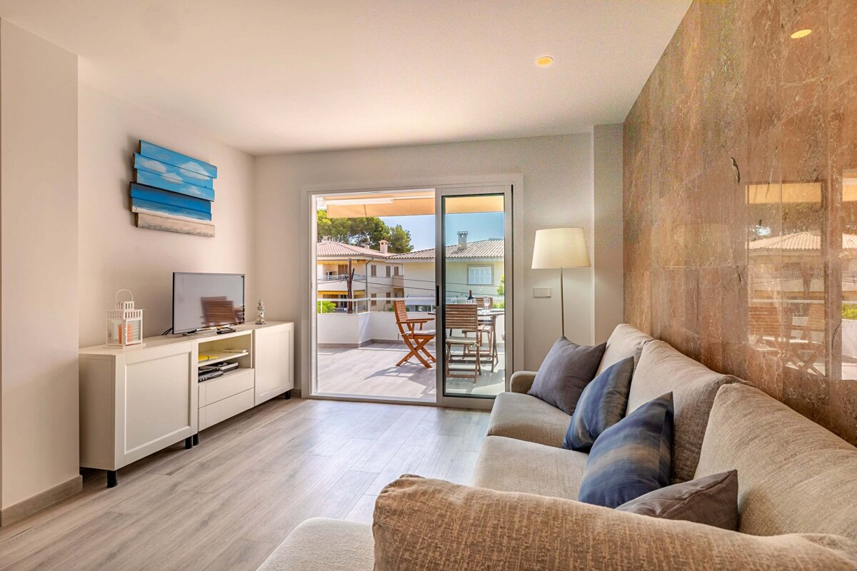 A living room with a couch and a flat screen tv