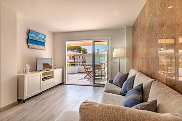 A living room with a couch and a flat screen tv