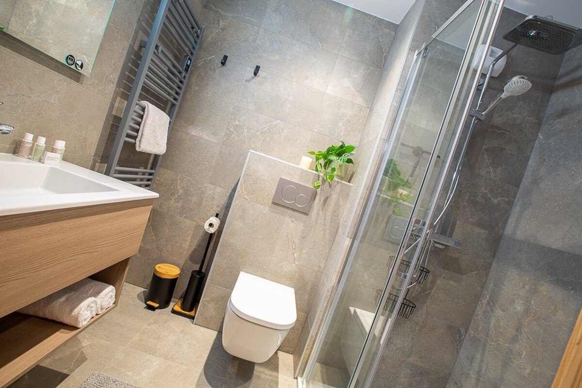 A bathroom with a toilet a sink and a shower