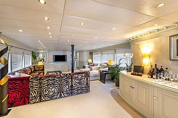 A living room with a zebra print couch and a tv