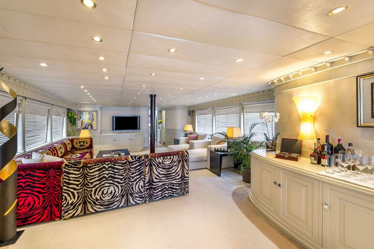 A living room with a zebra print couch and a tv