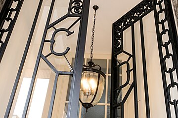 A wrought iron gate with the letter c on it