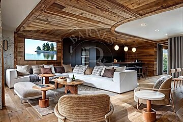 Modern rustic living room featuring rich wood paneling, a large white sectional sofa, stylish woven chairs, and a scenic lake view.