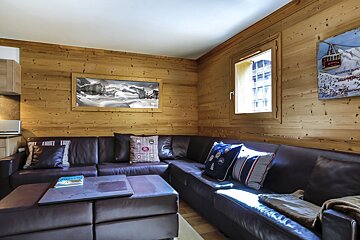 A living room with a picture of a ski lift on the wall