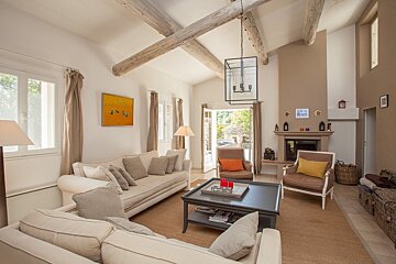 A living room with a couch and chairs and a fireplace