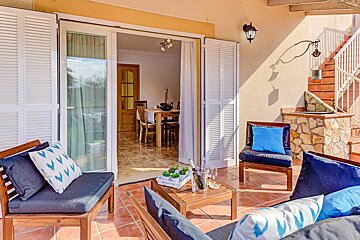 A patio with sliding glass doors leading to a dining room