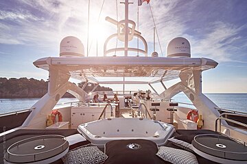 The back of a yacht with a jacuzzi on the deck