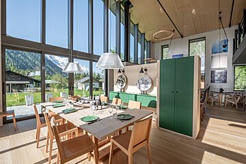 A dining room with a large table and chairs